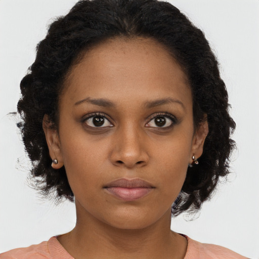 Neutral black young-adult female with long  brown hair and brown eyes