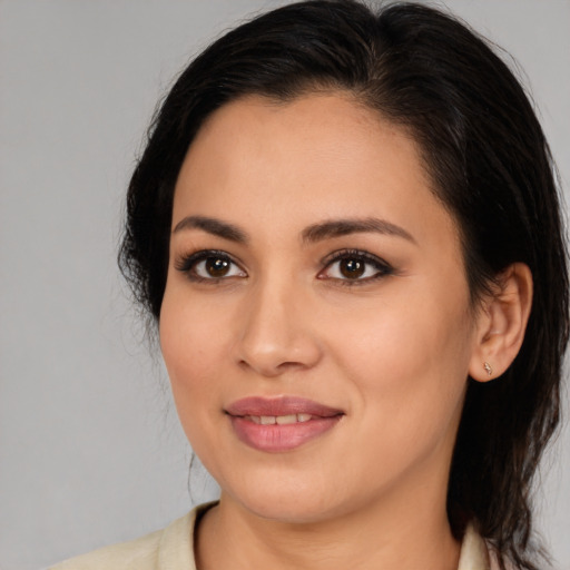 Joyful latino young-adult female with medium  black hair and brown eyes