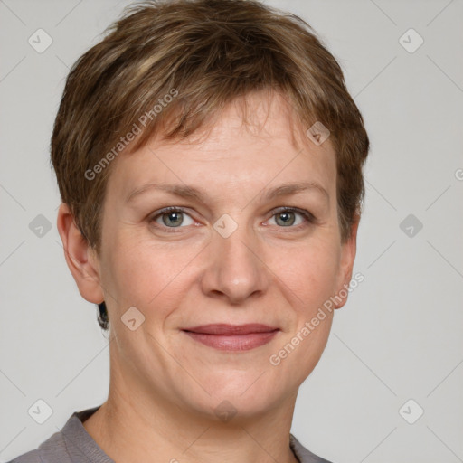 Joyful white adult female with short  brown hair and grey eyes