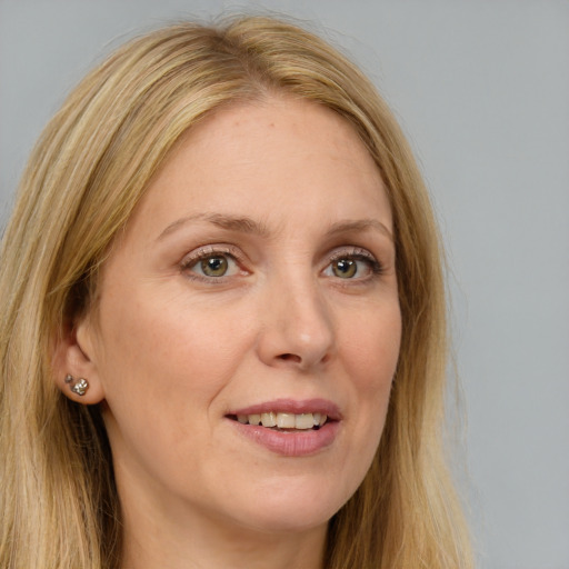 Joyful white adult female with long  brown hair and brown eyes