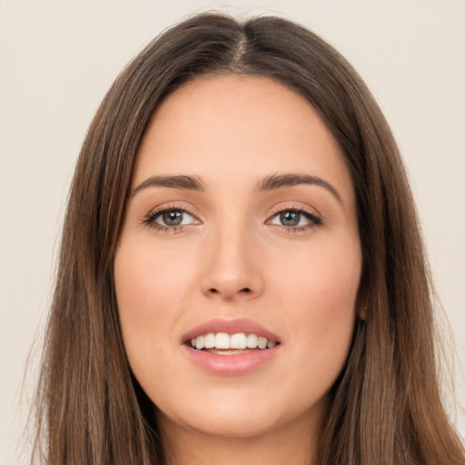 Joyful white young-adult female with long  brown hair and brown eyes