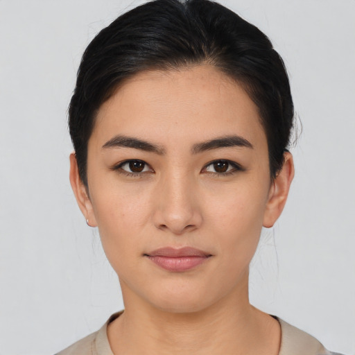 Joyful asian young-adult female with short  brown hair and brown eyes