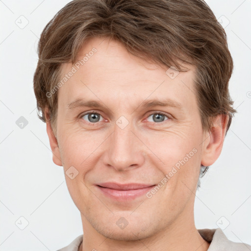 Joyful white adult male with short  brown hair and grey eyes