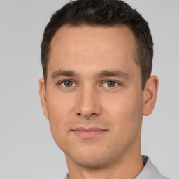 Joyful white young-adult male with short  brown hair and brown eyes