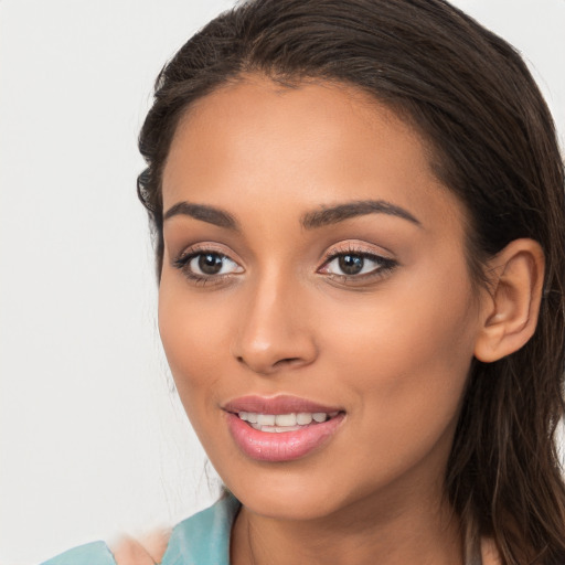 Joyful white young-adult female with long  brown hair and brown eyes