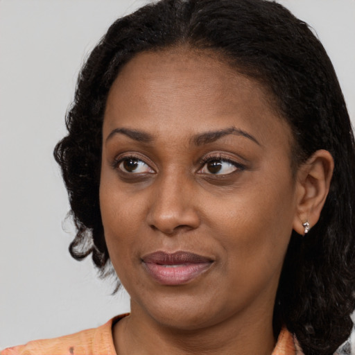 Joyful black young-adult female with medium  brown hair and brown eyes