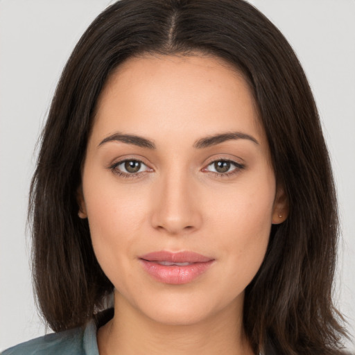 Joyful white young-adult female with long  brown hair and brown eyes