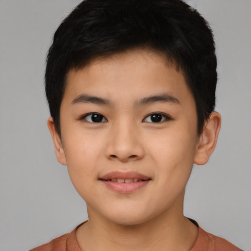 Joyful asian child male with short  brown hair and brown eyes