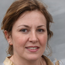 Joyful white adult female with medium  brown hair and grey eyes