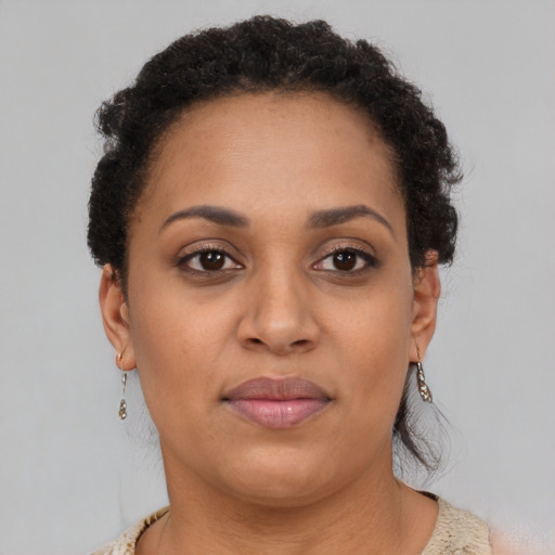 Joyful black adult female with short  brown hair and brown eyes
