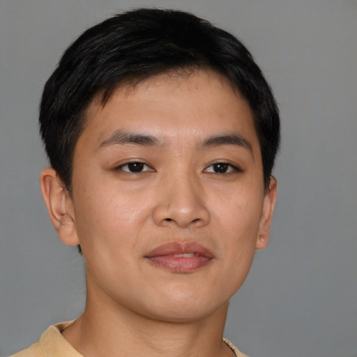 Joyful asian young-adult male with short  brown hair and brown eyes