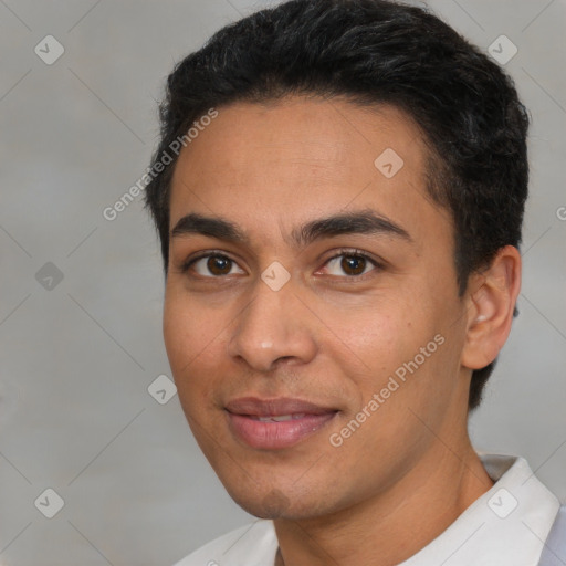 Joyful latino young-adult male with short  black hair and brown eyes