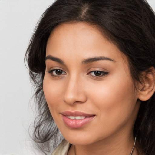 Joyful latino young-adult female with long  brown hair and brown eyes