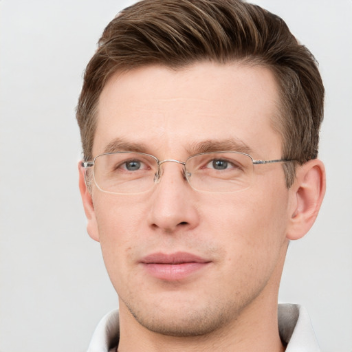 Joyful white adult male with short  brown hair and grey eyes