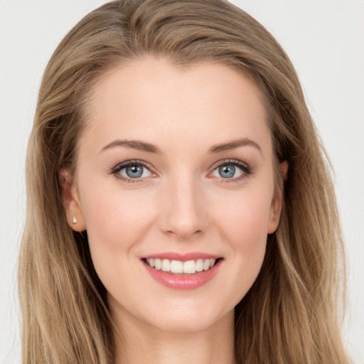 Joyful white young-adult female with long  brown hair and blue eyes