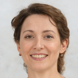 Joyful white young-adult female with medium  brown hair and green eyes