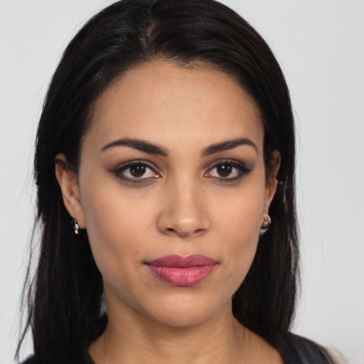 Joyful latino young-adult female with long  black hair and brown eyes