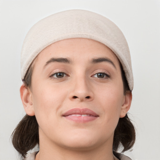 Joyful white young-adult female with medium  brown hair and grey eyes