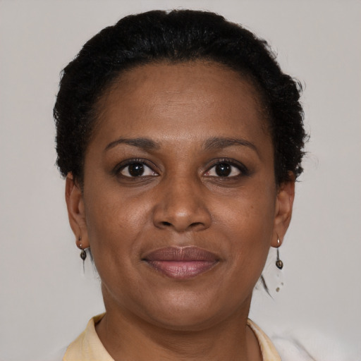 Joyful latino adult female with short  brown hair and brown eyes