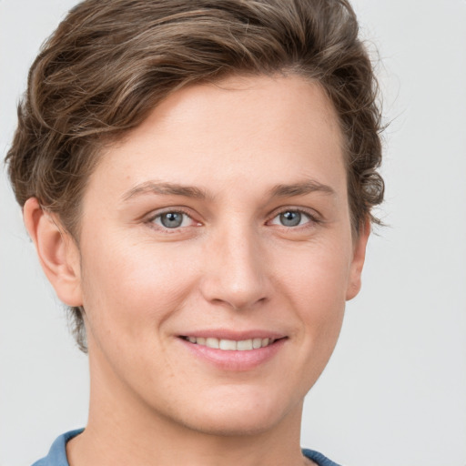 Joyful white young-adult female with short  brown hair and grey eyes