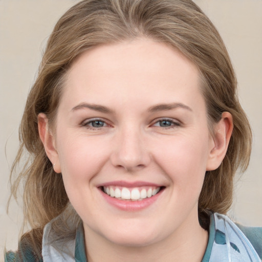 Joyful white young-adult female with medium  brown hair and blue eyes