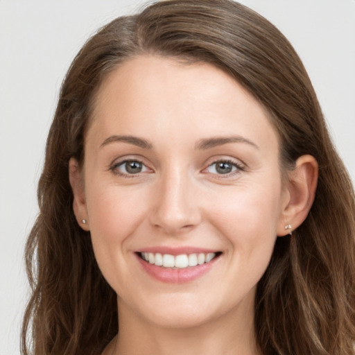 Joyful white young-adult female with long  brown hair and grey eyes