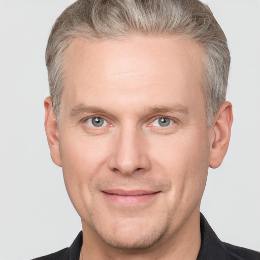 Joyful white adult male with short  brown hair and grey eyes