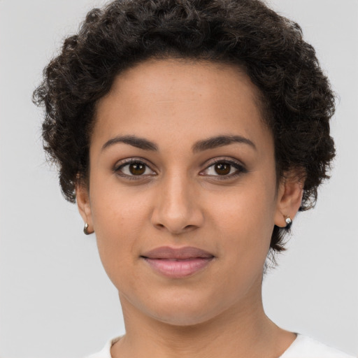 Joyful latino young-adult female with short  brown hair and brown eyes