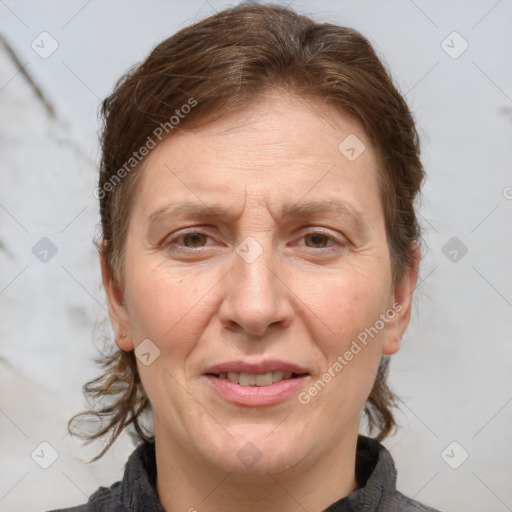 Joyful white adult female with medium  brown hair and brown eyes