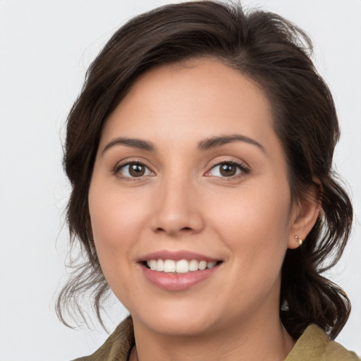 Joyful white young-adult female with medium  brown hair and brown eyes