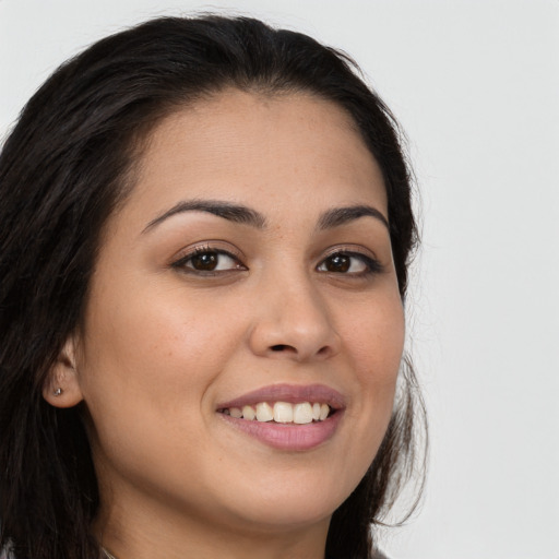 Joyful white young-adult female with long  brown hair and brown eyes