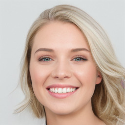 Joyful white young-adult female with long  brown hair and blue eyes