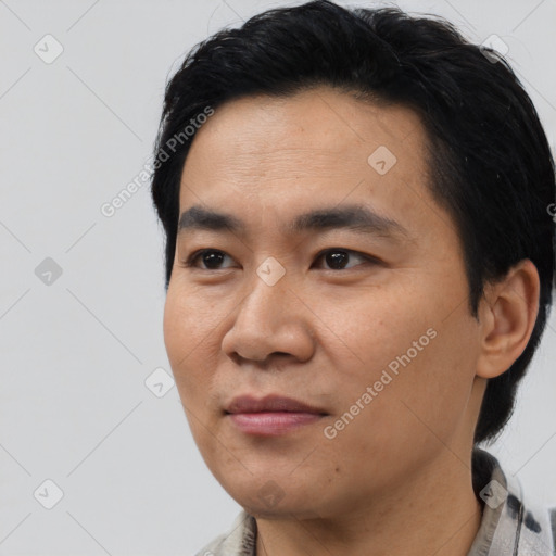 Joyful asian young-adult male with short  black hair and brown eyes