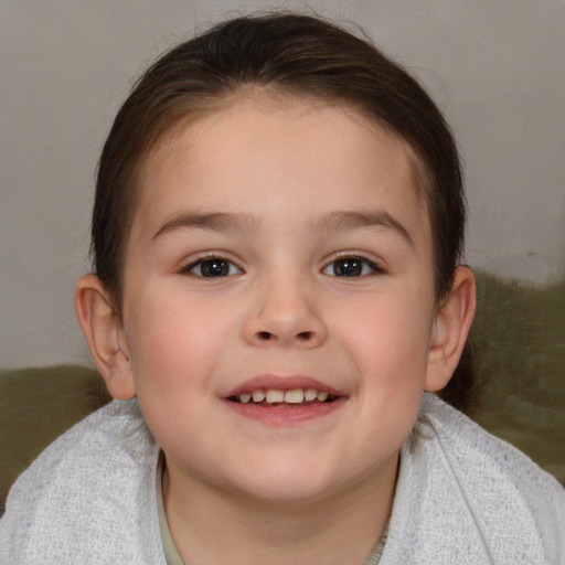 Joyful white child female with short  brown hair and brown eyes