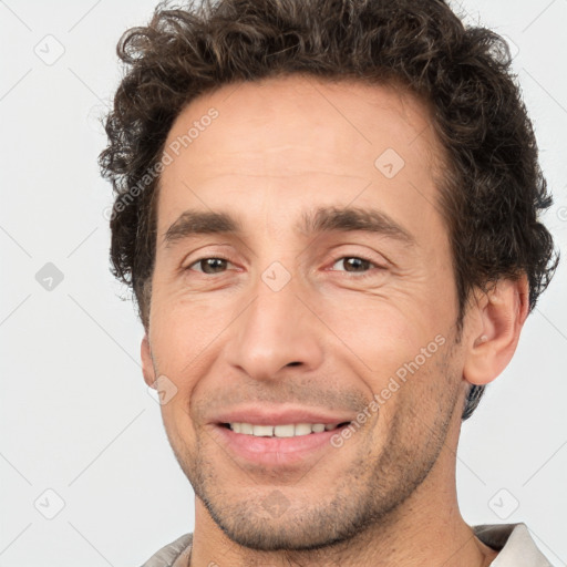 Joyful white adult male with short  brown hair and brown eyes