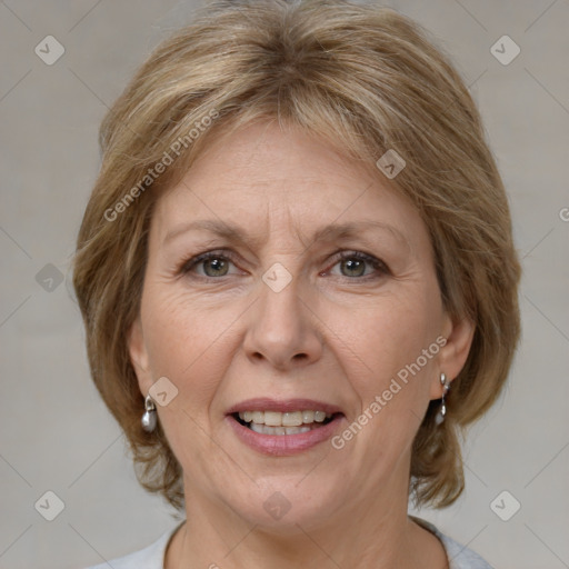 Joyful white adult female with medium  brown hair and grey eyes