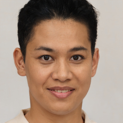 Joyful black young-adult female with short  brown hair and brown eyes
