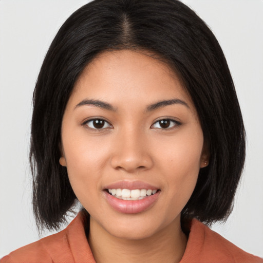 Joyful white young-adult female with long  black hair and brown eyes