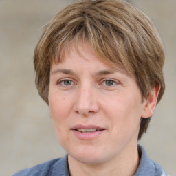 Joyful white adult female with medium  brown hair and blue eyes