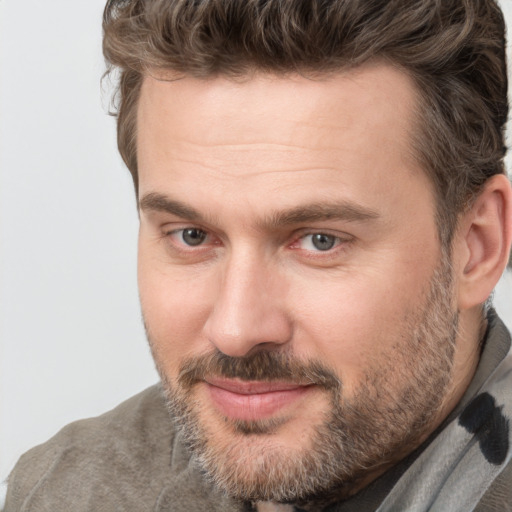 Joyful white adult male with short  brown hair and brown eyes