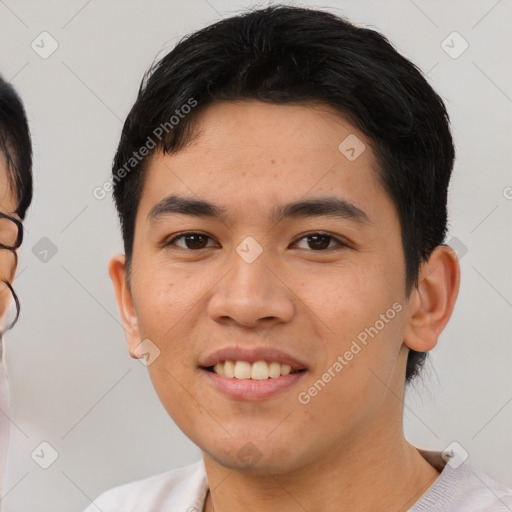 Joyful asian young-adult male with short  black hair and brown eyes