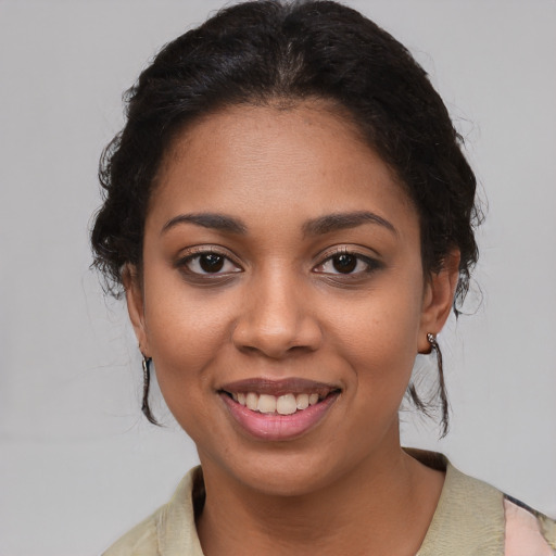 Joyful black young-adult female with medium  brown hair and brown eyes
