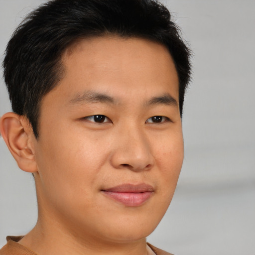 Joyful asian young-adult male with short  brown hair and brown eyes