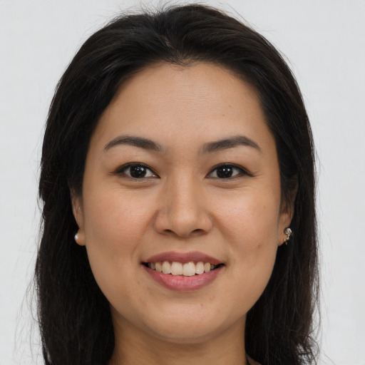 Joyful asian young-adult female with long  brown hair and brown eyes