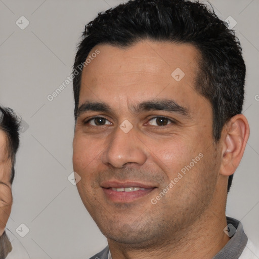 Joyful white young-adult male with short  black hair and brown eyes