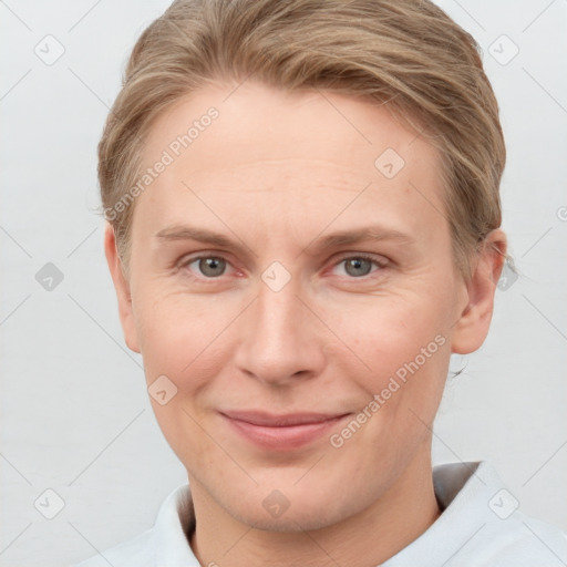 Joyful white young-adult female with short  brown hair and grey eyes