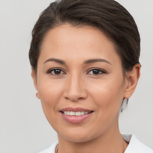 Joyful white young-adult female with short  brown hair and brown eyes