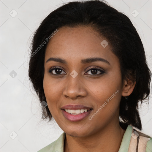 Joyful black young-adult female with long  brown hair and brown eyes