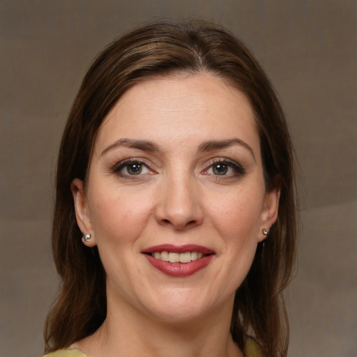 Joyful white young-adult female with medium  brown hair and grey eyes