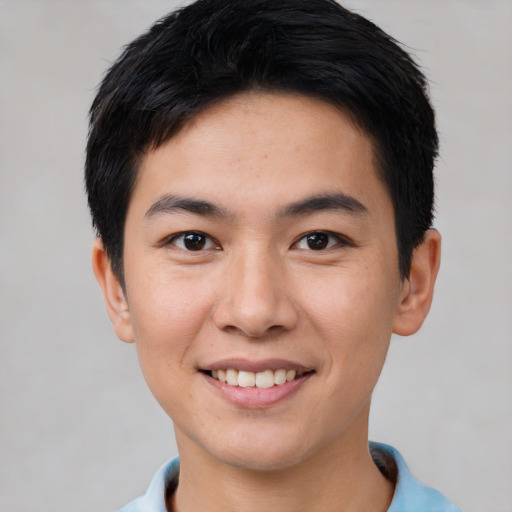 Joyful asian young-adult male with short  black hair and brown eyes